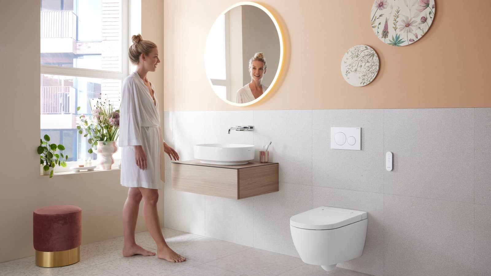 Woman in bathroom with Geberit AquaClean Alba Woman in bathroom with Geberit AquaClean Alba