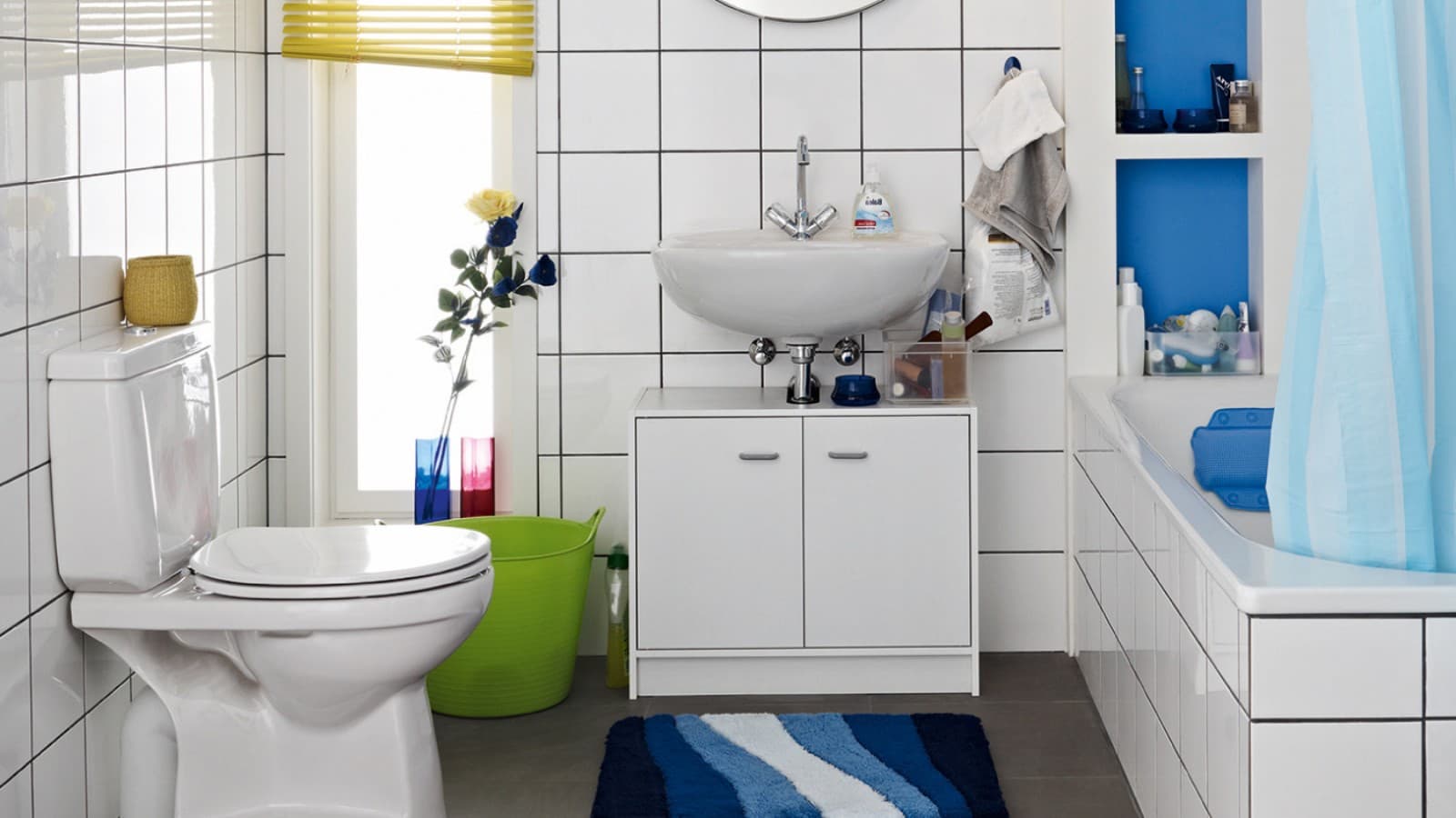 Cluttered bathroom seen before the renovation, with floor-standing WC and exposed cistern Cluttered bathroom seen before the renovation, with floor-standing WC and exposed cistern