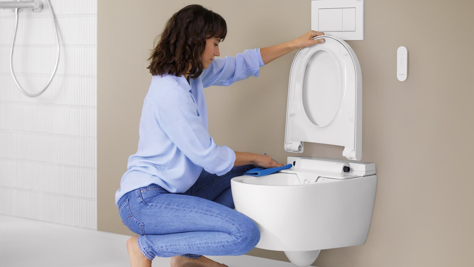 Woman cleans Geberit AquaClean Alba Woman cleans Geberit AquaClean Alba