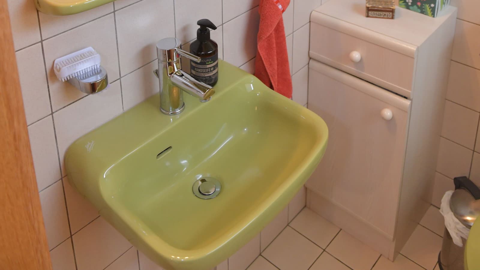 The guest bathroom with a small cabinet and washbasin The guest bathroom with a small cabinet and washbasin